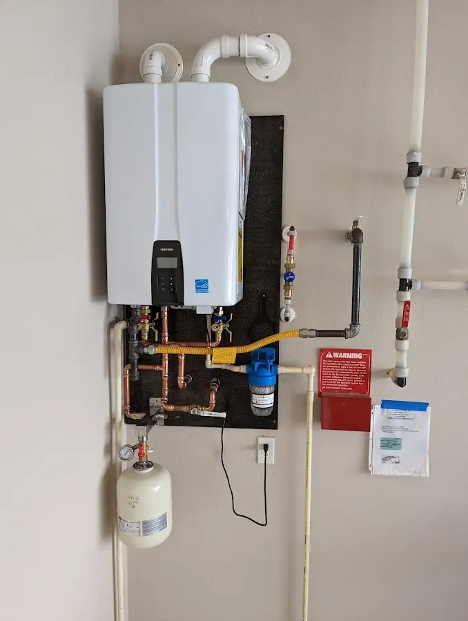 Professional plumber installing copper piping in a Fort Morgan home